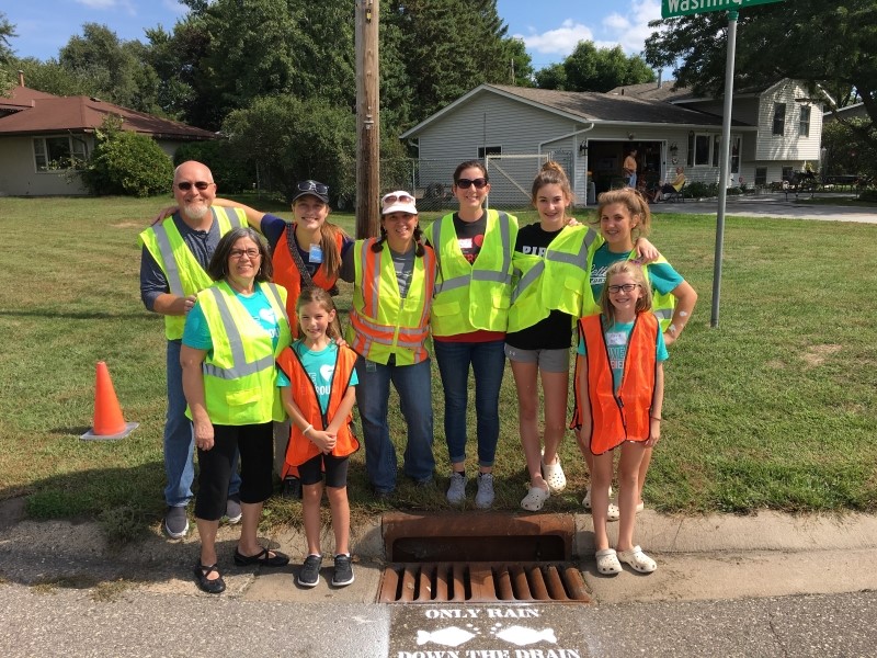 Group with stencilled stormdrain - Only Rain Down the Drain