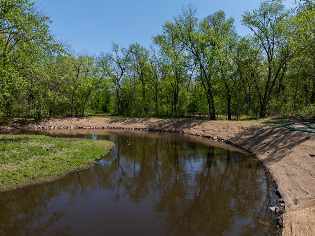 Photo of streambank with stabilization measures in place prior to vegetation regrowth